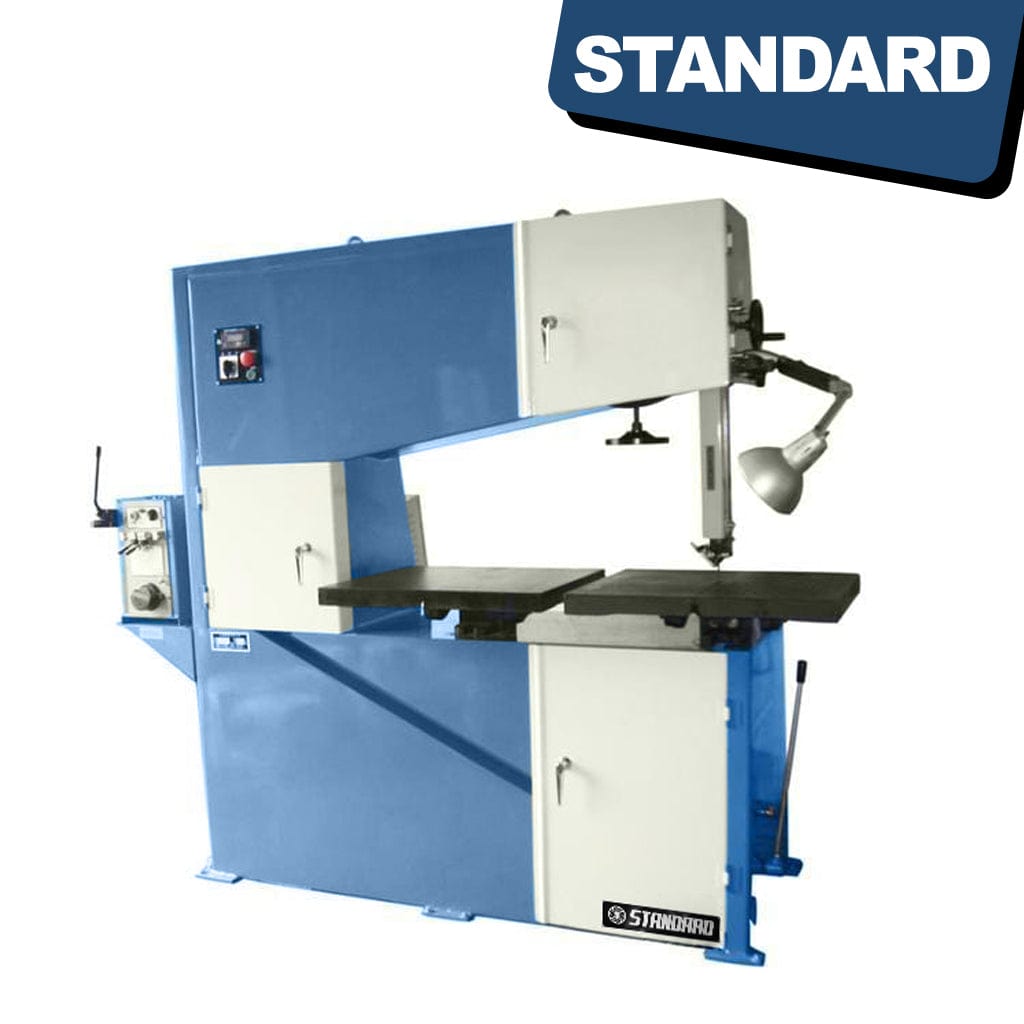 STANDARD BV-320x1000 Vertical Bandsaw. A tall, vertical bandsaw machine with a metallic frame and various knobs, levers, and a cutting blade positioned vertically. The machine is designed for precision cutting of materials and features a control panel on the front.