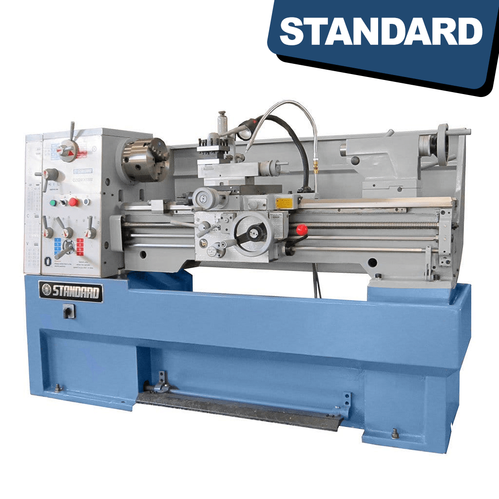 An image of the STANDARD T-410x1000 Solid Base Precision Lathe, a metallic industrial machine with various knobs, levers, and a long rotating spindle, used for metalworking and shaping materials with high precision.
