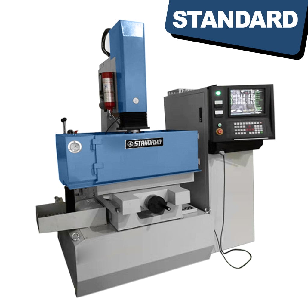 STANDARD EDS-350x250 CNC Spark Eroder, a specialized machining tool. The equipment is depicted in a workshop setting, displaying a metallic structure with control panels and components. The CNC Spark Eroder is designed for precise material removal using electrical discharges. The photograph emphasizes the industrial nature of the machine, situated in a manufacturing environment.