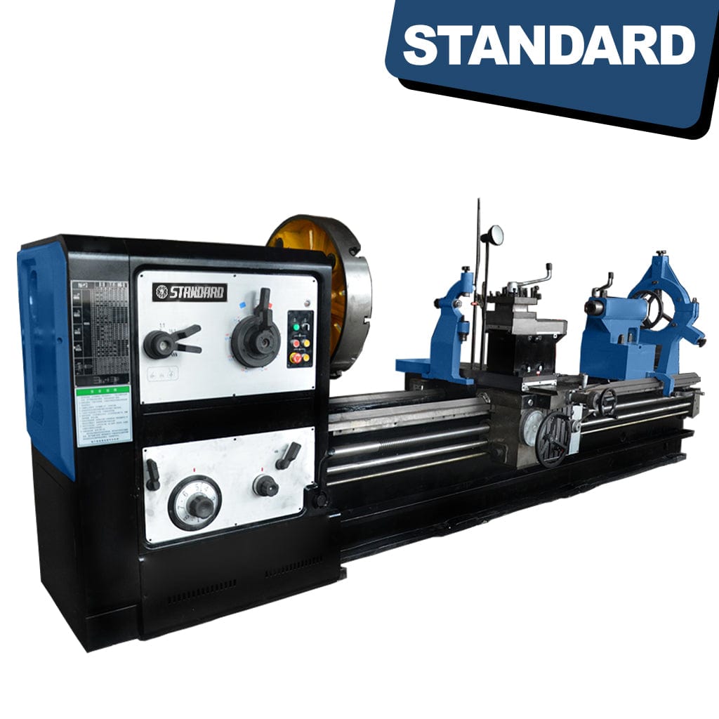 Gears and control panel of the STANDARD TC-1100x3000 Heavy Duty Horizontal Lathe, an industrial machine. The control panel features buttons and levers for operating the lathe, while visible gears and mechanical components facilitate metalworking tasks.