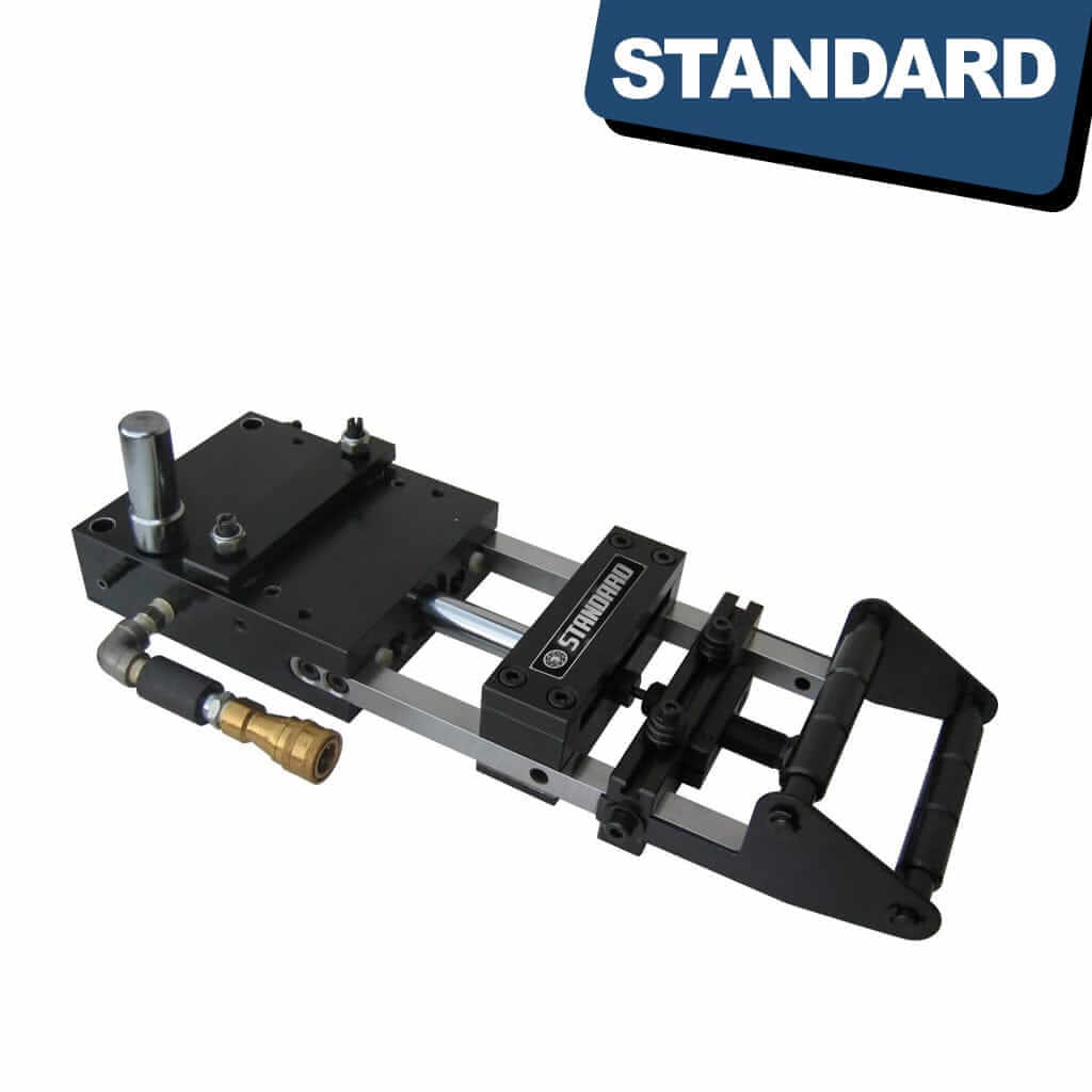 A close-up image of a STANDARD AF-8C Pneumatic Feeder, a compact machine with a hopper on top for storing screws and a nozzle at the bottom for dispensing them. The machine is made of sturdy metal and has adjustable speed and feed settings. It is designed for precision screw feeding in industrial operations, available from STANDARD and Standard Direct.