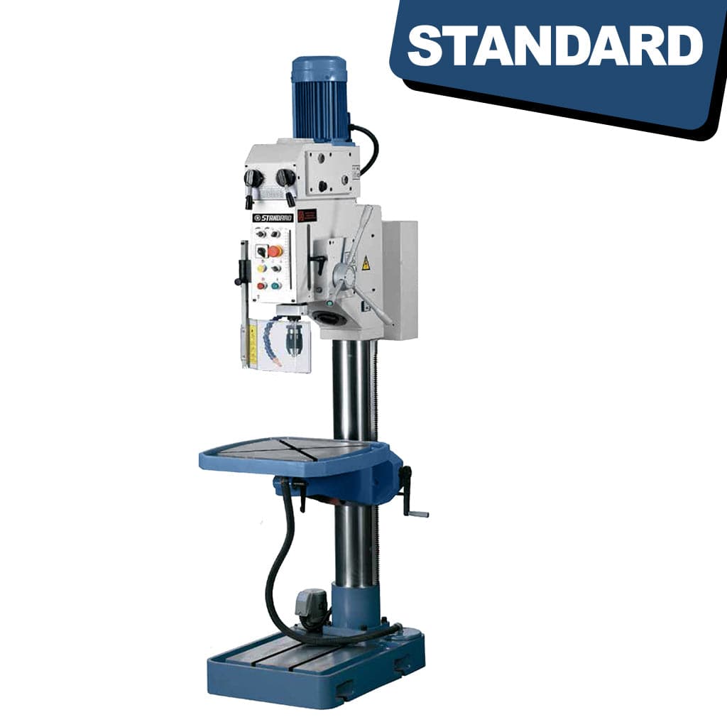 An image showing the STANDARD DG-40 Gearbox Head Pedestal Drilling Machine. The machine consists of a sturdy vertical stand with a metal arm extending horizontally. At the end of the arm is the drilling mechanism with adjustable settings and a chuck to hold various drill bits. The base of the machine is equipped with controls and knobs for operating the drill, while the stand provides stability and support.