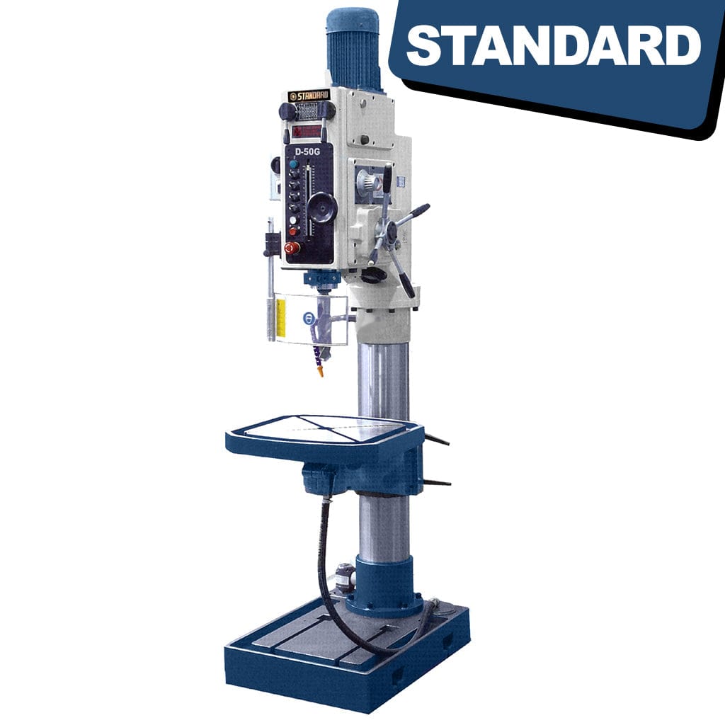 An image of the STANDARD DG-50 Gearbox Head Pedestal Drilling Machine, a tall vertical drilling equipment with a sturdy base and a vertical spindle. The machine features gears, handles, and controls for precision drilling operations.