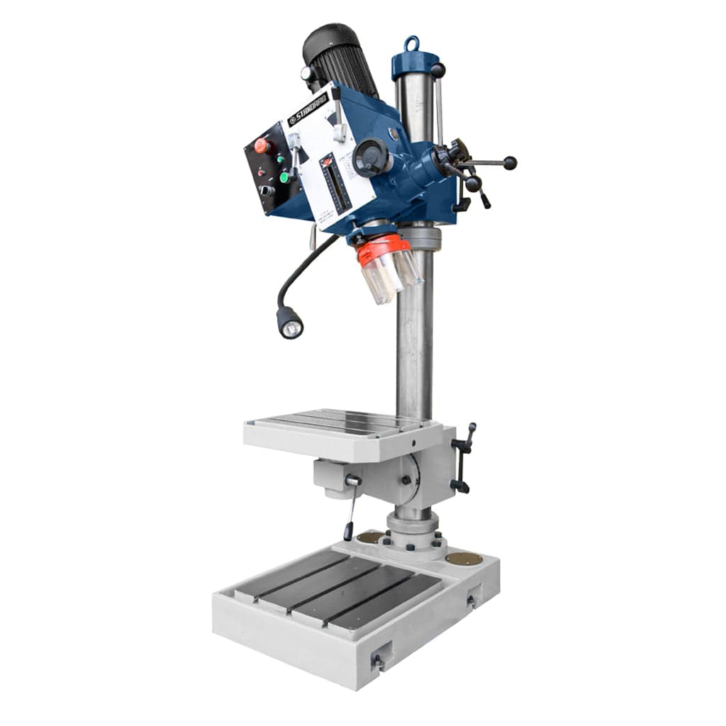 A side-view image of the STANDARD DG-35 Gearbox Head Pedestal Drilling Machine, showing its vertical structure, motorized gearbox head, adjustable components, and the drill bit positioned above the worktable for drilling tasks.
